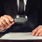 Businessman Reading Contract Details Before Signing